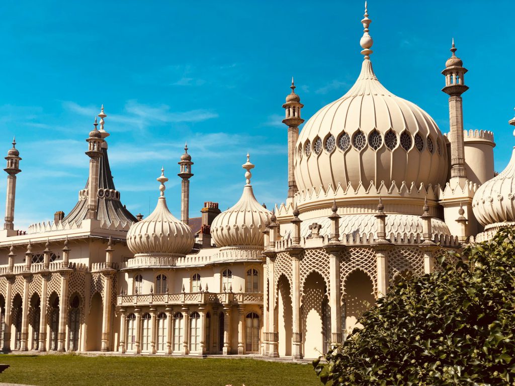 a large white building with lots of domes on top of it 